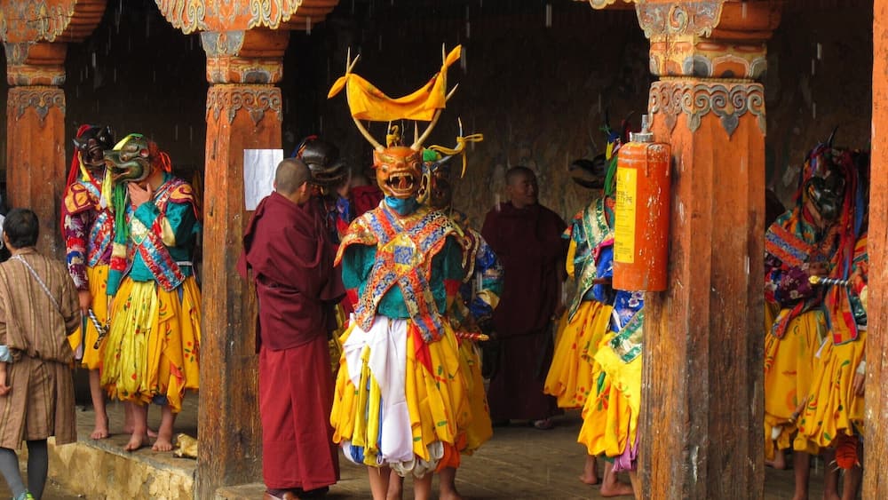 A traditional ceremony with colorful costumes and ornate architecture.