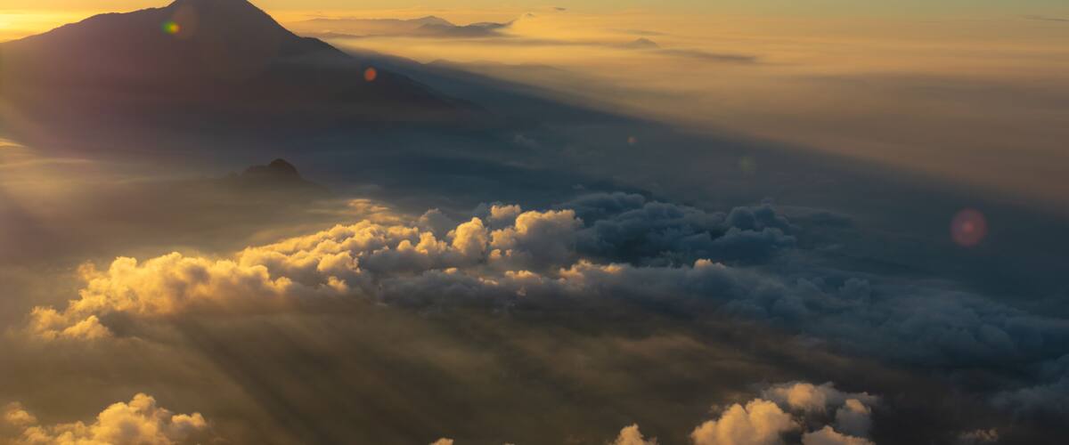 A mountain range with clouds below.