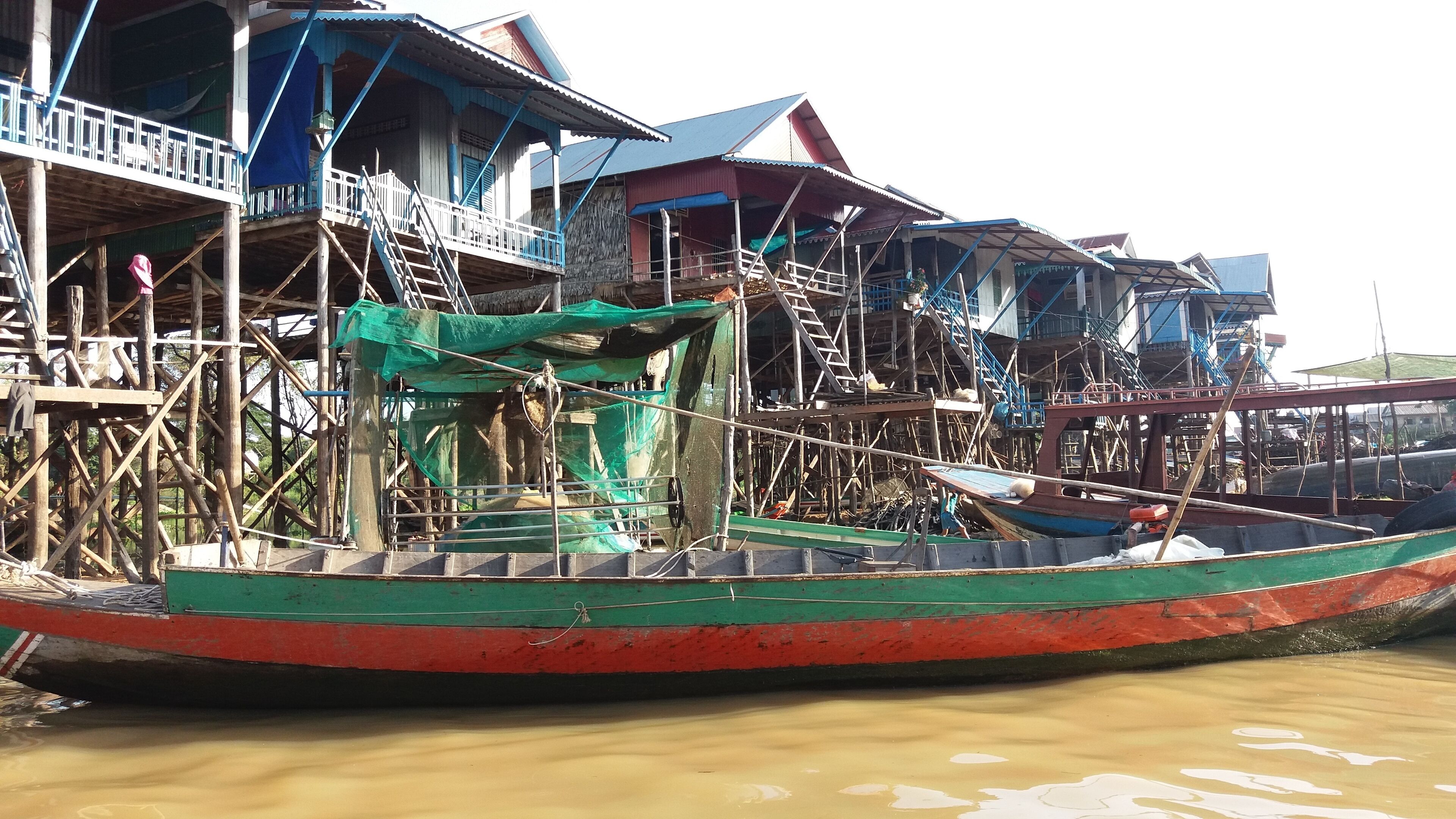 A traditional stilt house by a river.