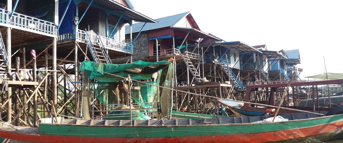 A traditional stilt house by a river.