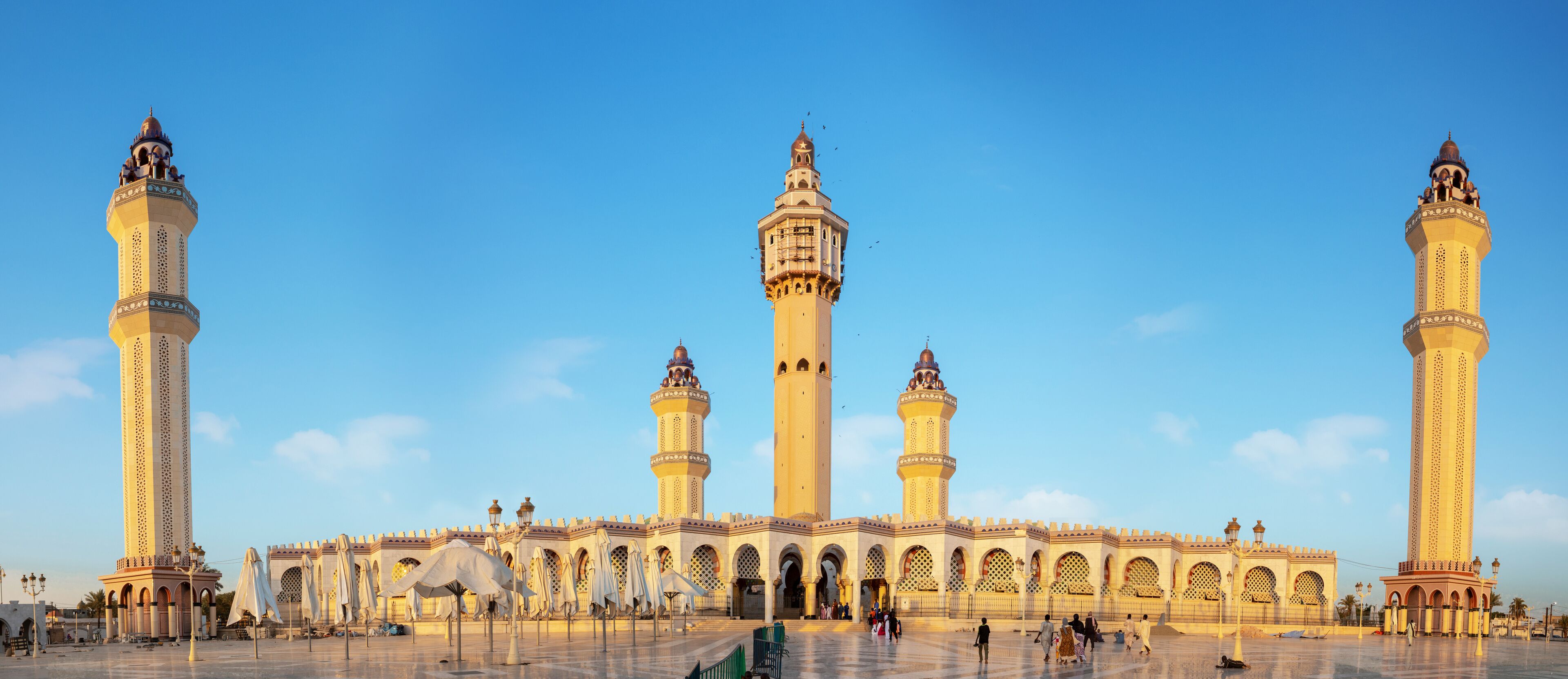 A large mosque with multiple minarets and a courtyard.