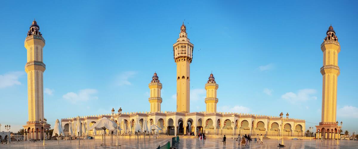 A large mosque with multiple minarets and a courtyard.