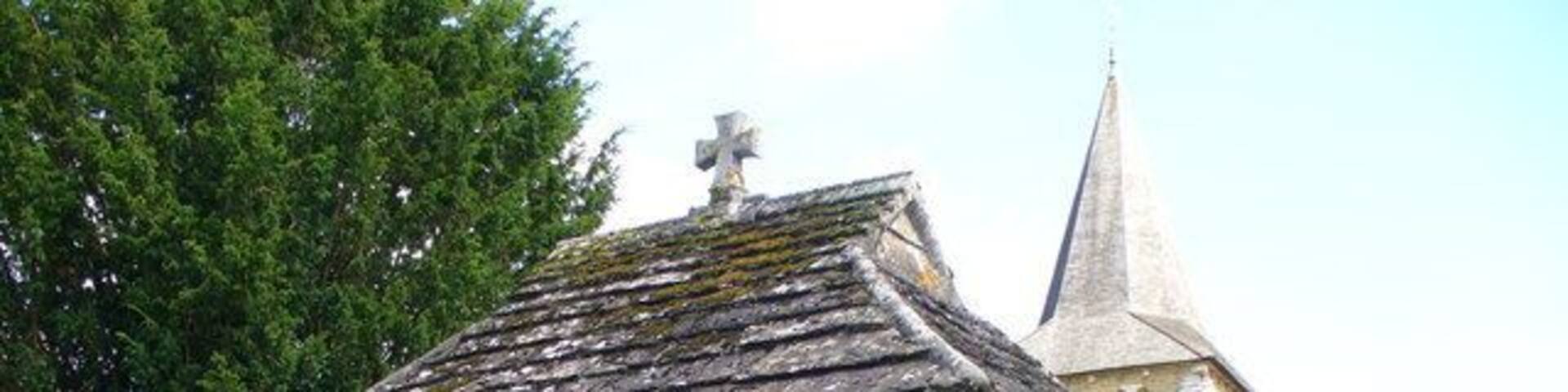 Lych Gate, Ewhurst Outside St Peter and St Paul, the lych gate is roofed with "Horsham Flags", local stone.