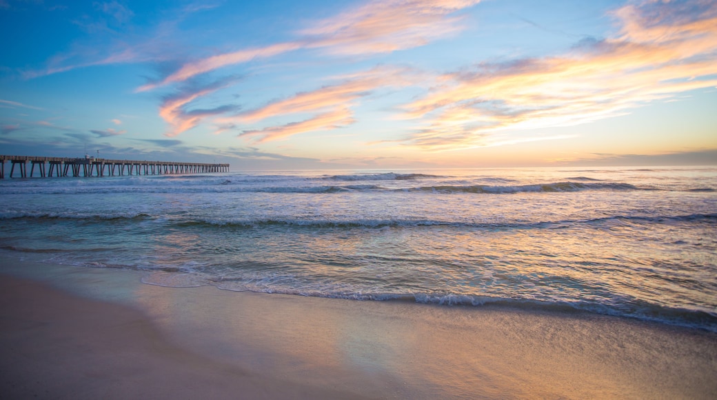 panama city beach florida ocean at shoreline with beautiul sunset clouds and pier into the water
