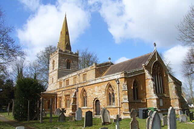 A historic church with a tall tower and arched windows.