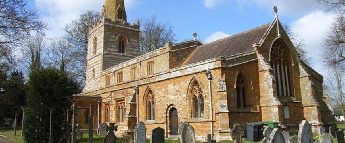 A historic church with a tall tower and arched windows.
