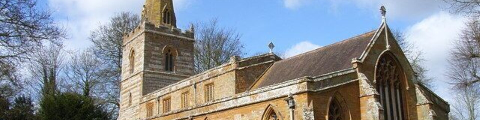 A historic church with a tall tower and arched windows.