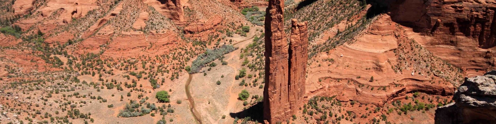 Spider Rock at Canyon De Chelly in Arizona. The tallest of the two sandstone spires is 750 feet (229 m) and located at the far end of the southern rim. The park is a great place for hiking and offers many opportunities to see ancient cave dwellings.