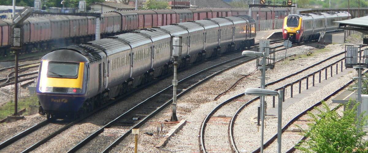 A railway yard with multiple tracks and trains.
