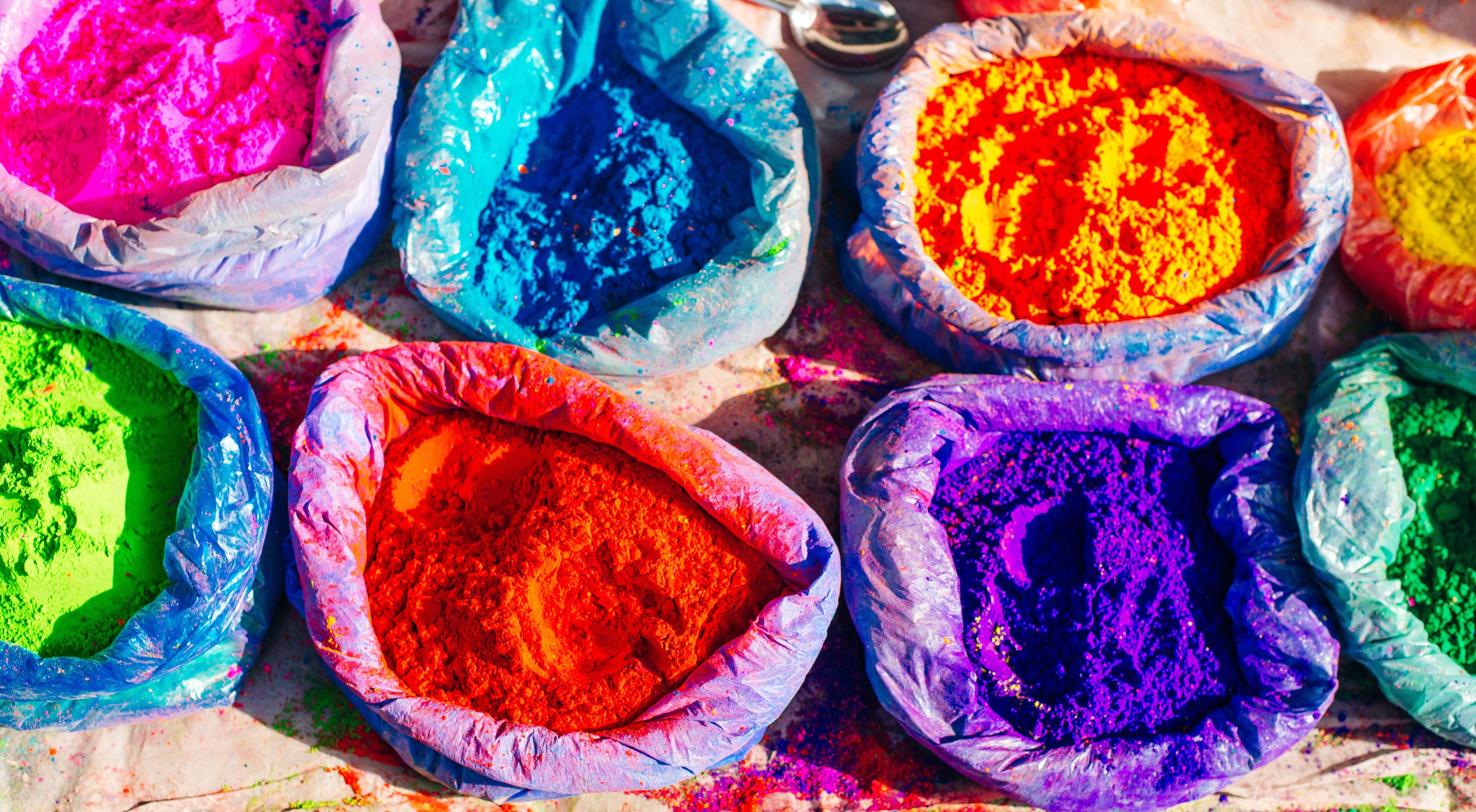Multiple bags filled with colorful powders.