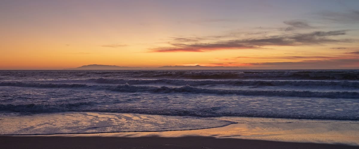 Sunset view of the Channel Islands seen from beach in Ventura California United States