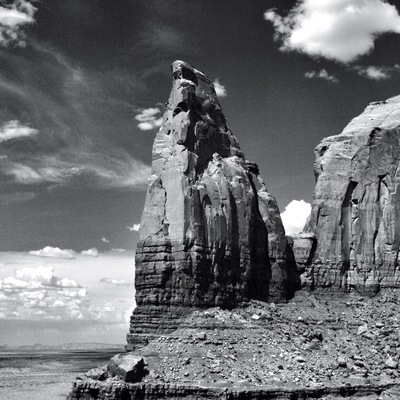 Giant stone pillars are everywhere in monument valley national park.
This great valley boasts sandstone masterpieces that tower at heights of 400 to 1,000 feet. framed by scenic clouds casting shadows that graciously roam the desert floor. The angle of the sun accents these graceful formations, providing scenery that is simply spellbinding.
The landscape overwhelms, not just by its beauty but also by its size.  The fragile pinnacles of rock are surrounded by miles of mesas and buttes, shrubs, trees and windblown sand, all comprising the magnificent colors of the valley.  All of this harmoniously combines to make Monument Valley a truly wondrous experience.  Enjoy this beautiful land.