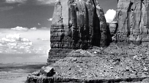 Giant stone pillars are everywhere in monument valley national park.
This great valley boasts sandstone masterpieces that tower at heights of 400 to 1,000 feet. framed by scenic clouds casting shadows that graciously roam the desert floor. The angle of the sun accents these graceful formations, providing scenery that is simply spellbinding.
The landscape overwhelms, not just by its beauty but also by its size. The fragile pinnacles of rock are surrounded by miles of mesas and buttes, shrubs, trees and windblown sand, all comprising the magnificent colors of the valley. All of this harmoniously combines to make Monument Valley a truly wondrous experience. Enjoy this beautiful land.