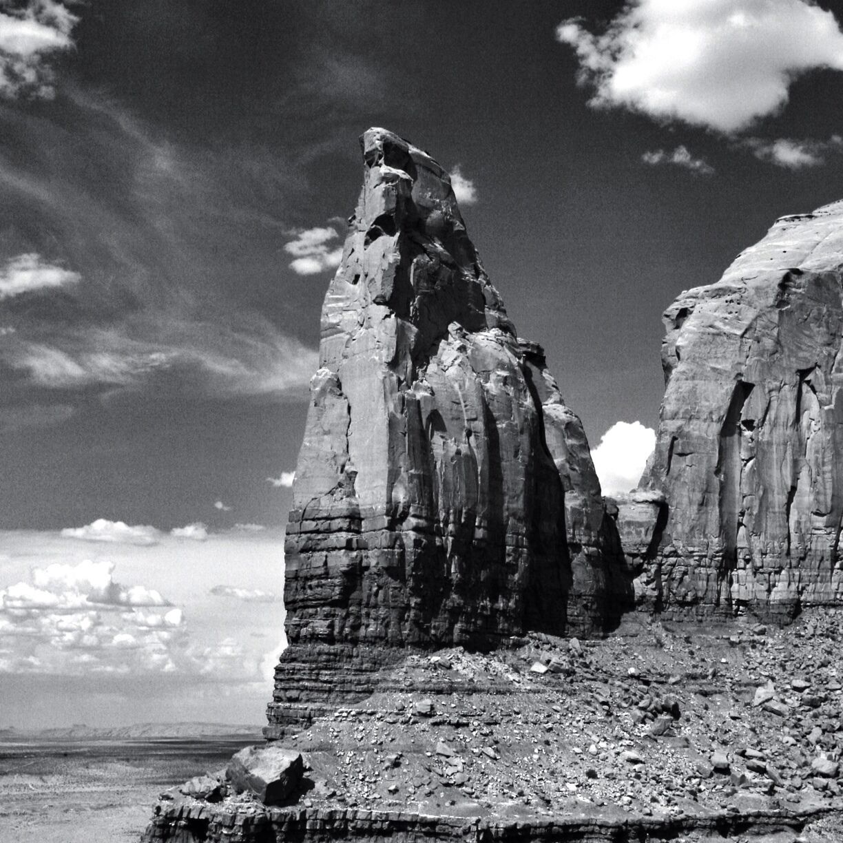 A rugged rock formation with layered strata and a clear sky.
