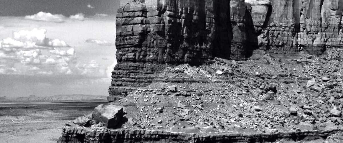 A rugged rock formation with layered strata and a clear sky.