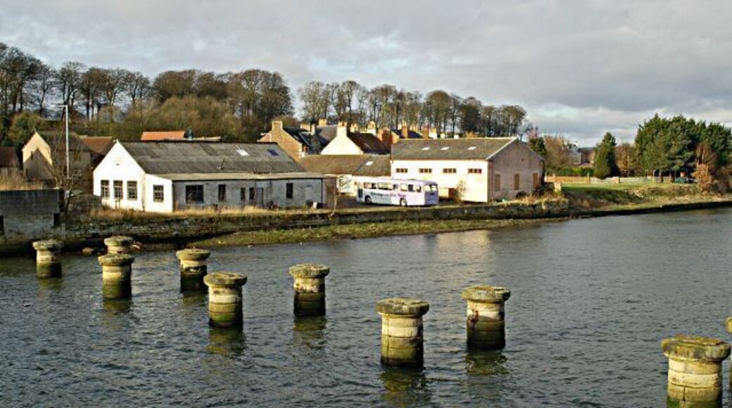 The pillars mark the position of an old railway bridge built in 1852 by Thomas Bouch who was made infamous in 1879 by the collapse of the Tay Railway Bridge which he also engineered. The railway was closed in 1969. The factory in the background is a paper mill operated by Curtis Fine Papers.
