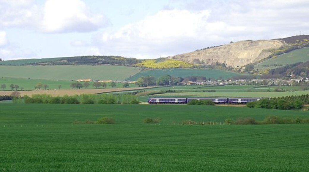 By Seggie Looking towards Balmullo and Lucklaw with its Redstone quarry. The Edinburgh bound train is picking up speed having just left Leuchars.