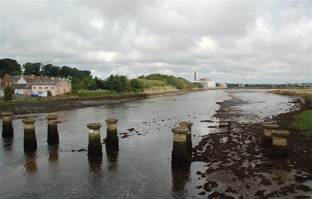 Crossing The Eden Estuary The pillars mark the position of the old railway bridge, built in 1852 by Thomas Bouch. He was made infamous in 1879 by the collapse of the Tay Railway Bridge, which he also engineered. The railway was closed in 1969. The factory in the background, and in the next square, is the paper mill operated by Curtis Fine Papers.