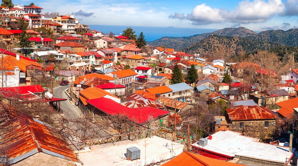 Pedoulas cozy village in Troodos mountains, Cyprus, panoramic view. Scenic cityscape with tiled roofs and blue sky, Marathasa valley, Lefkosia (Nicosia) district