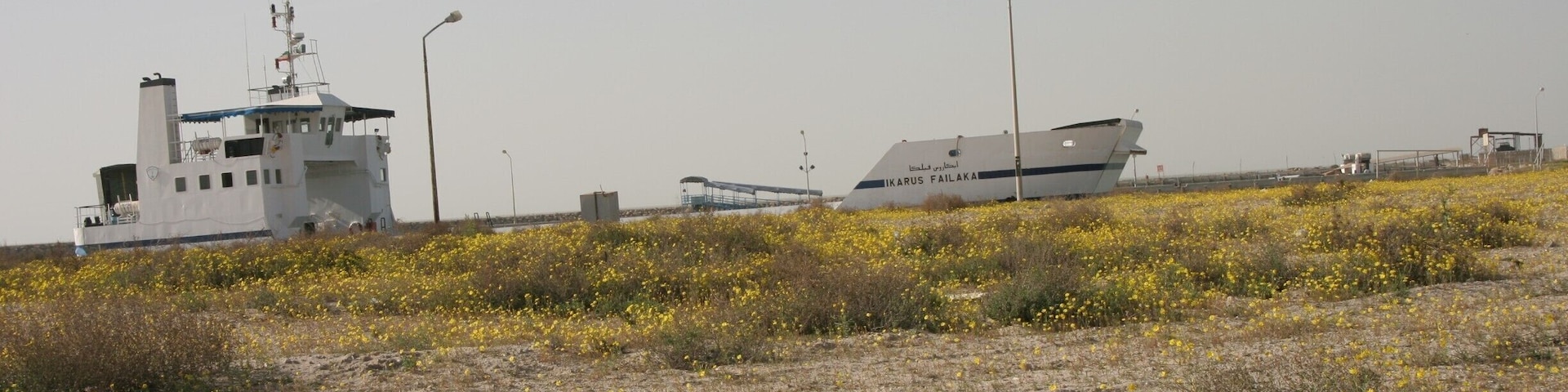 The vehicular barge from Kuwait City to Failaka Island.  There are no amenities on board and in 2006 the timings were erratic and there was no schedule in English or English speakers at the terminal, but somehow I still managed to get there and back again...  It looks like the Heritage Village has been restored and is up and running again, so there are probably more facilities here now.
http://www.safirhotels.com/hotel.aspx