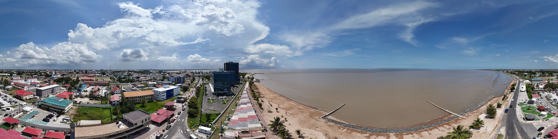 360 aerial photo taken with drone of Kingston Seawall Esplanade and Seawall bandstand on sunny afternoon in Georgetown, Guyana