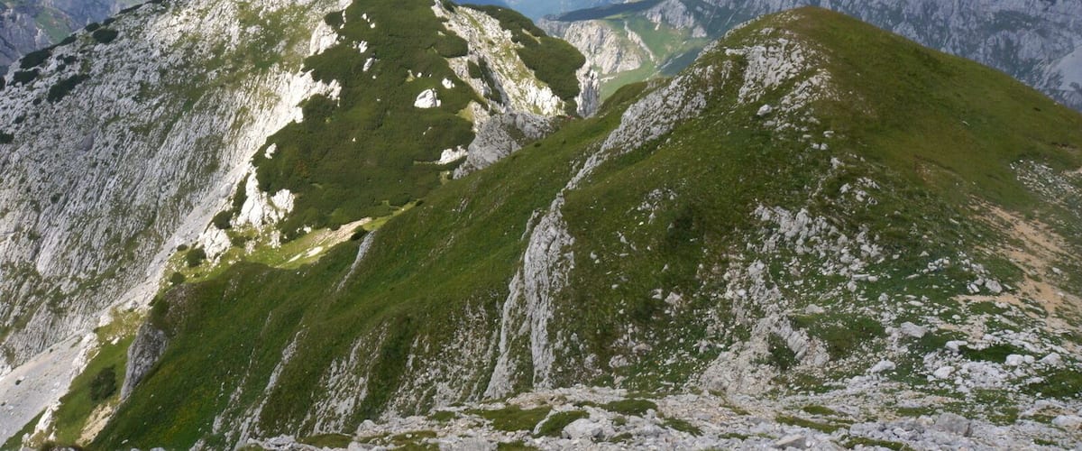 Panorama from the summit of Prutas is amazing! From here it is most beautiful view of Skrka Valley and highest peak of Durmitor, Bobotov Kuk, which rules on the other side of the valley, on the NE. Also very close is colorful Stit with its amazing twisted layers of limestone cliffs, on the E. On the N is Susica canyon and Ljubisnja mountain farther away. On the S are vast grassy plateaus and basins of Durmitor closed by elegant Sedlena Greda and picturesque ridges of Boljska Greda and Lojanik. Further away is Vojnik mountain and on clear days views spreads far south, ell the way to Orjen massif and the Adriatic coast. On the W are even larges grassy plateaus of Pivska Planina. Behind it is beautiful group of mountains led by Bioc and Maglic, highest peak of Bosnia & Herzegovina.