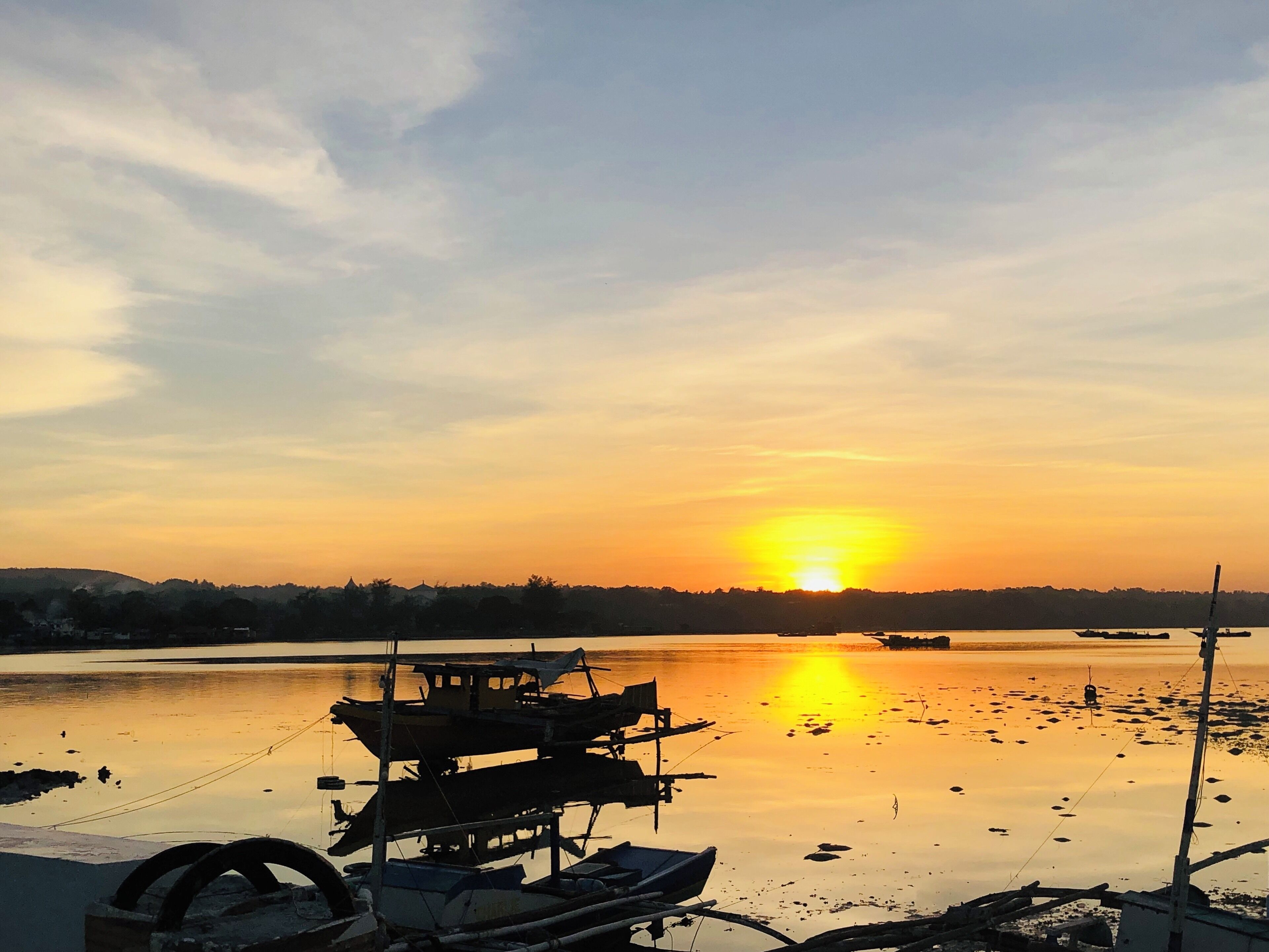 A fishing boat sits during low tide in a fishing village in Bohol, Philippines. #culture #sunset