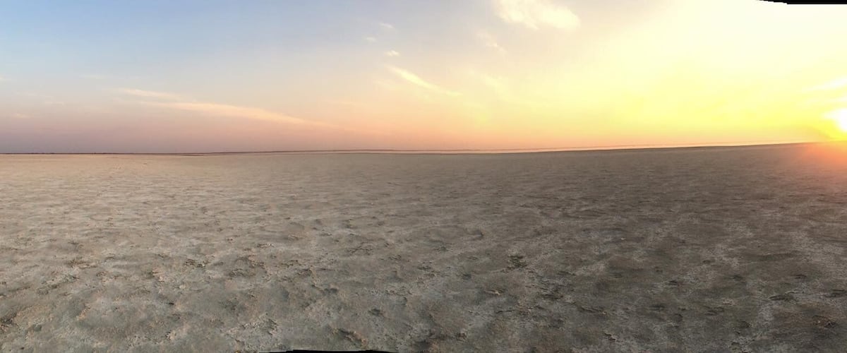 Sunset on the salt pans. Thousands of flamingoes on the horizon. Could mostly hear them rather than see them