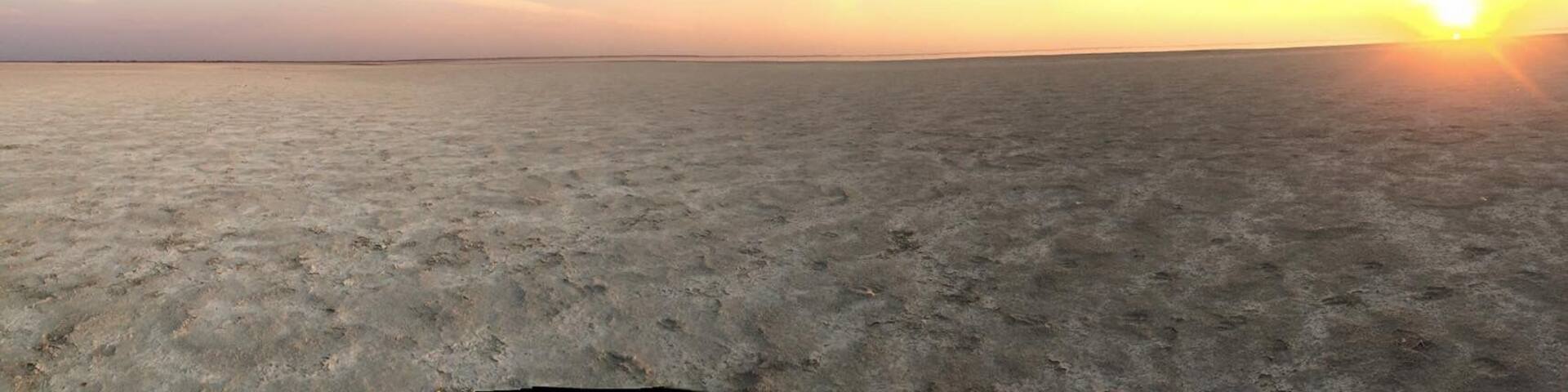 Sunset on the salt pans. Thousands of flamingoes on the horizon. Could mostly hear them rather than see them