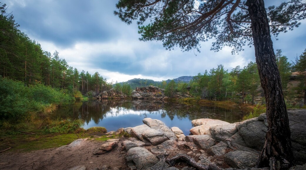 lake among rocks and forest on sunny autumn day. The famous Devil Lake in Karkaralinsk national park in Kazakhstan