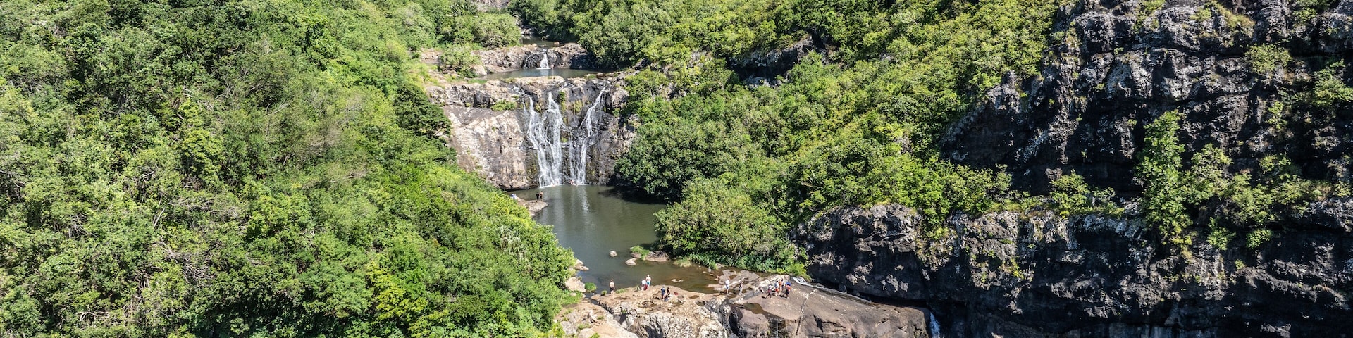 Aerial landscape view of Tamarind Falls, known as Seven Cascades in the tropical island jungle of Mauritius surrounded by lush green forested mountains