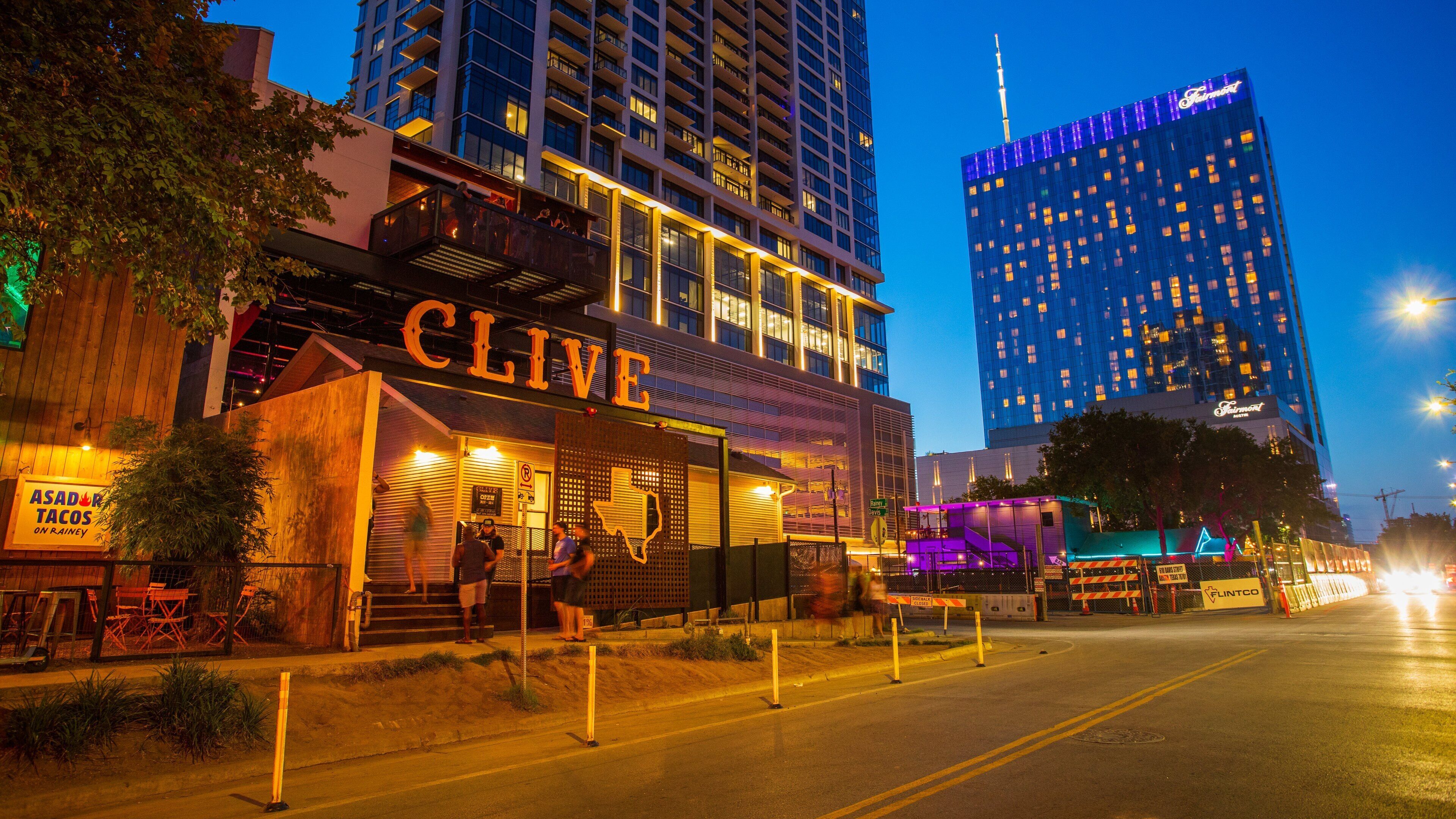 Rainey Street featuring night scenes, signage and a city