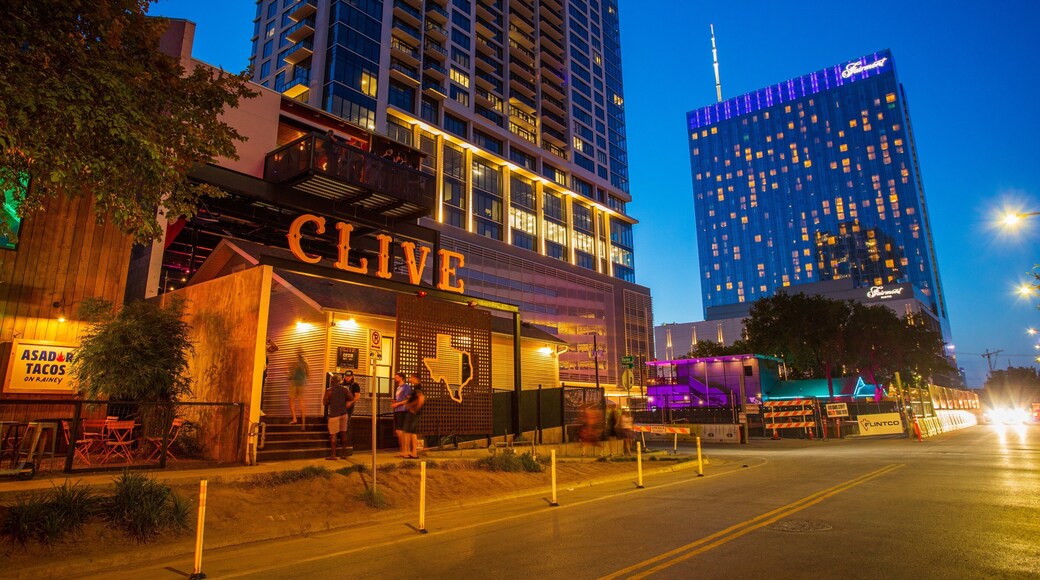 Rainey Street featuring night scenes, signage and a city
