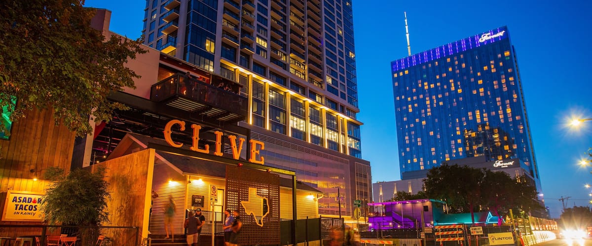 Rainey Street featuring night scenes, signage and a city
