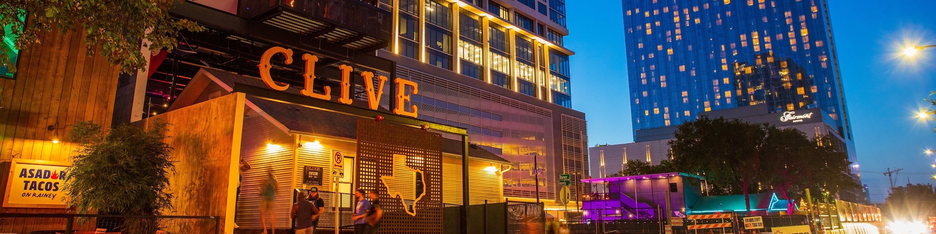 Rainey Street featuring night scenes, signage and a city