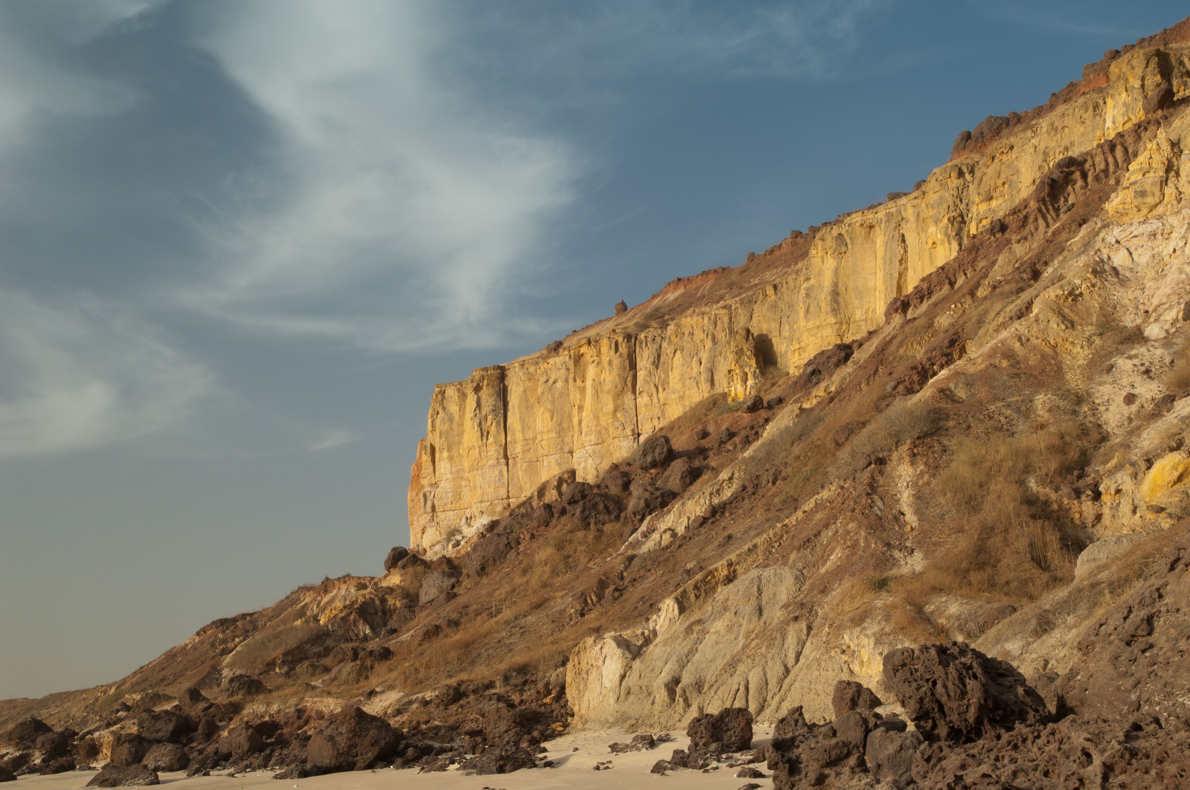 A rocky cliff with a clear sky.