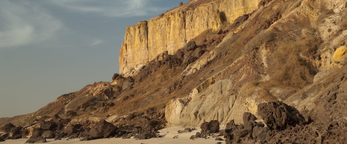 A rocky cliff with a clear sky.