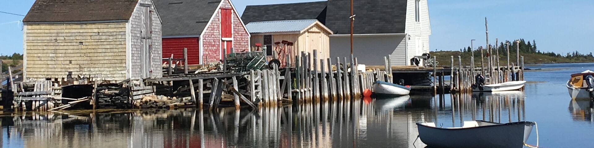 A waterfront with wooden buildings and boats.