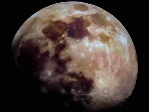 A celestial body with visible craters and surface markings.
