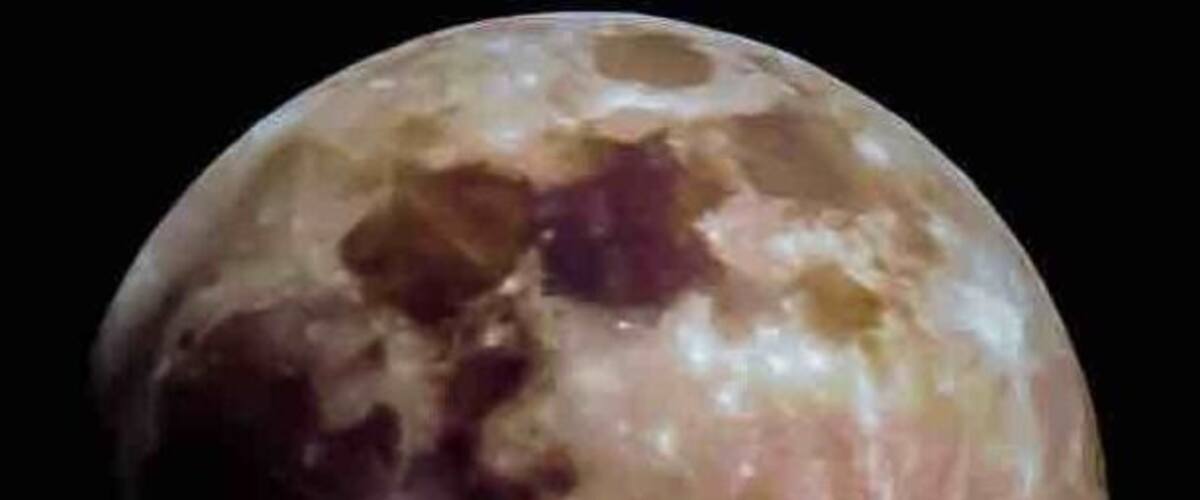 A celestial body with visible craters and surface markings.