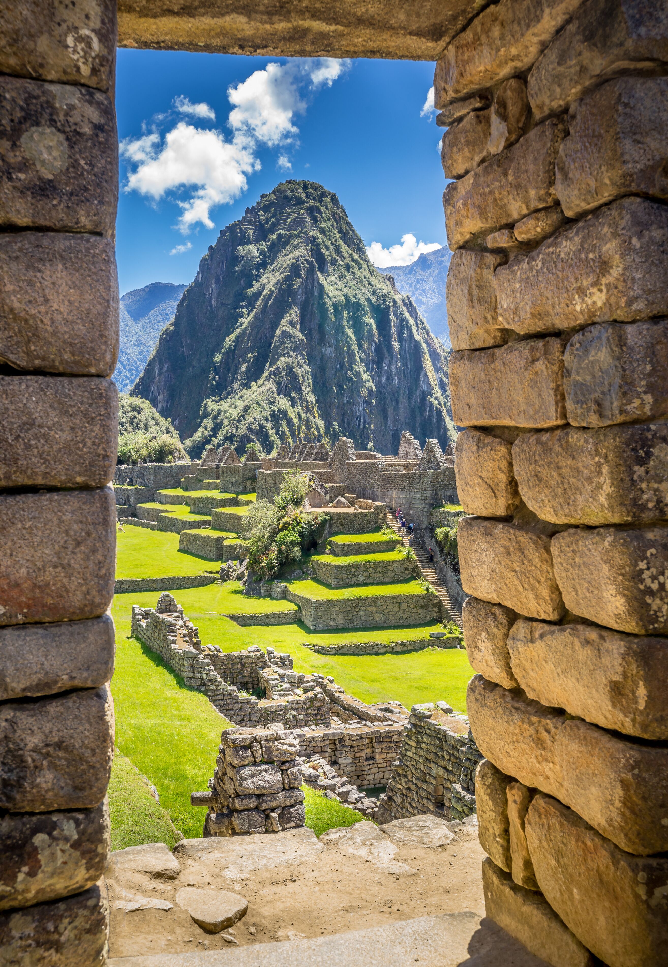 The Inca ruins of Machu Picchu, UNESCO World Heritage Site through the frame of stone wall