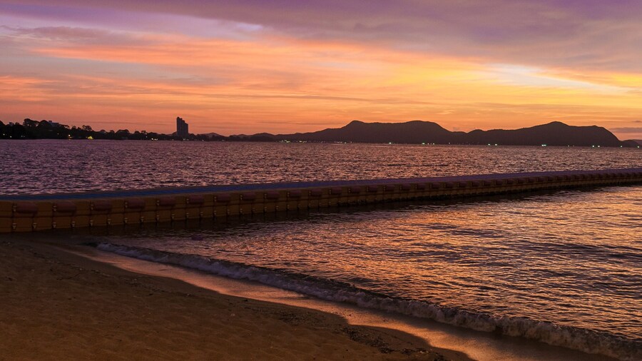 Beach in Pattaya during sunset in Thailand Ban Amphur beach. a tropical beach with palm trees during sunset