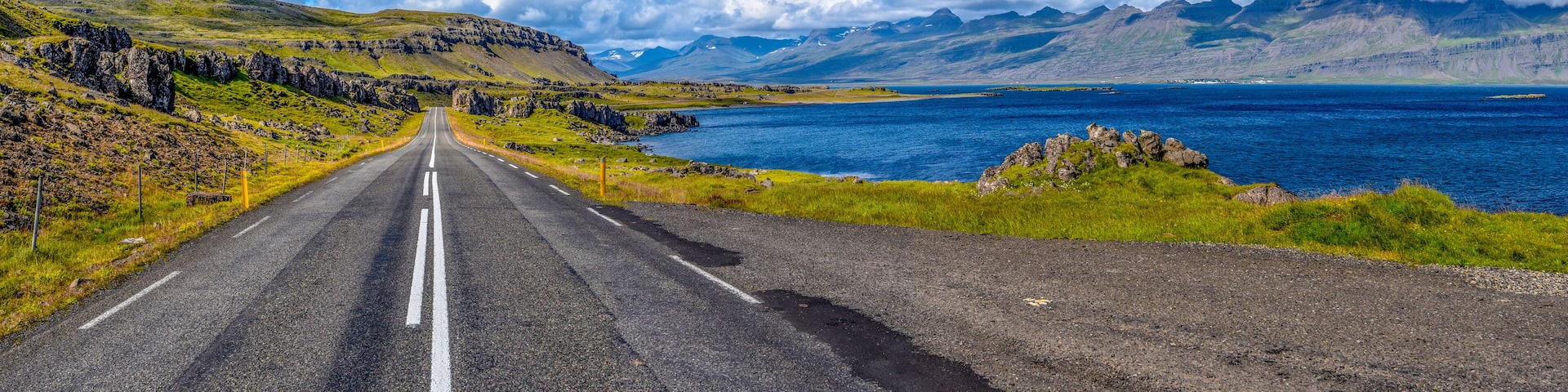 Ring road 1 in Eastern Iceland with the panoramic view at Stodvar Fjord at right.