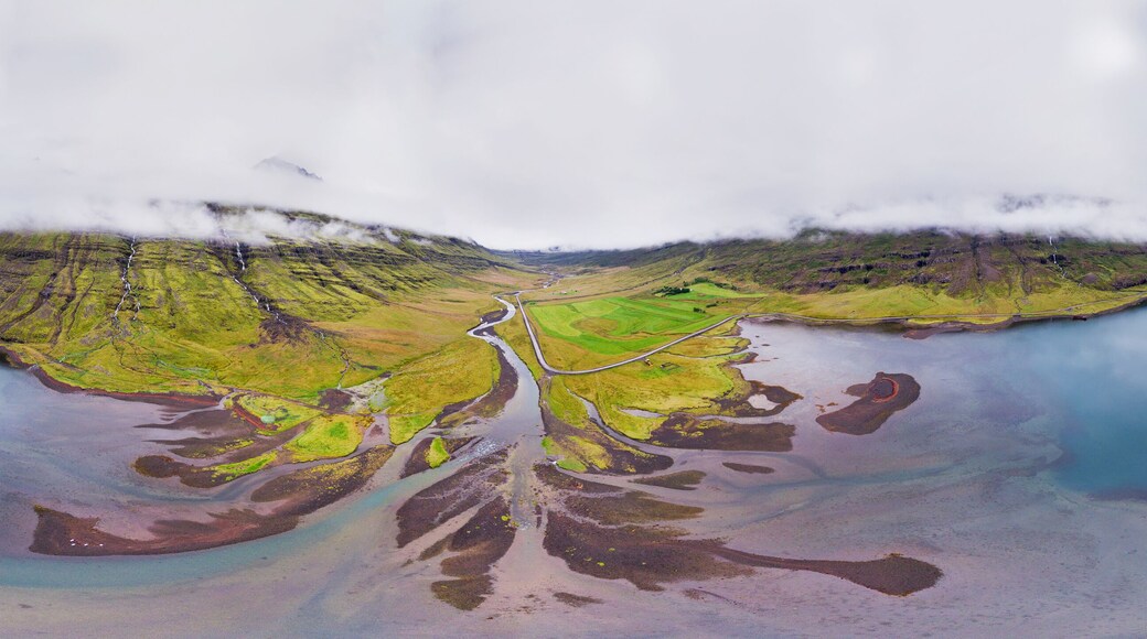 Aerial 360 degrees panorama of low clouds above a fjord with sandbanks, Mjoifjordur, Fjardabyggd, Eastfjords of Iceland.