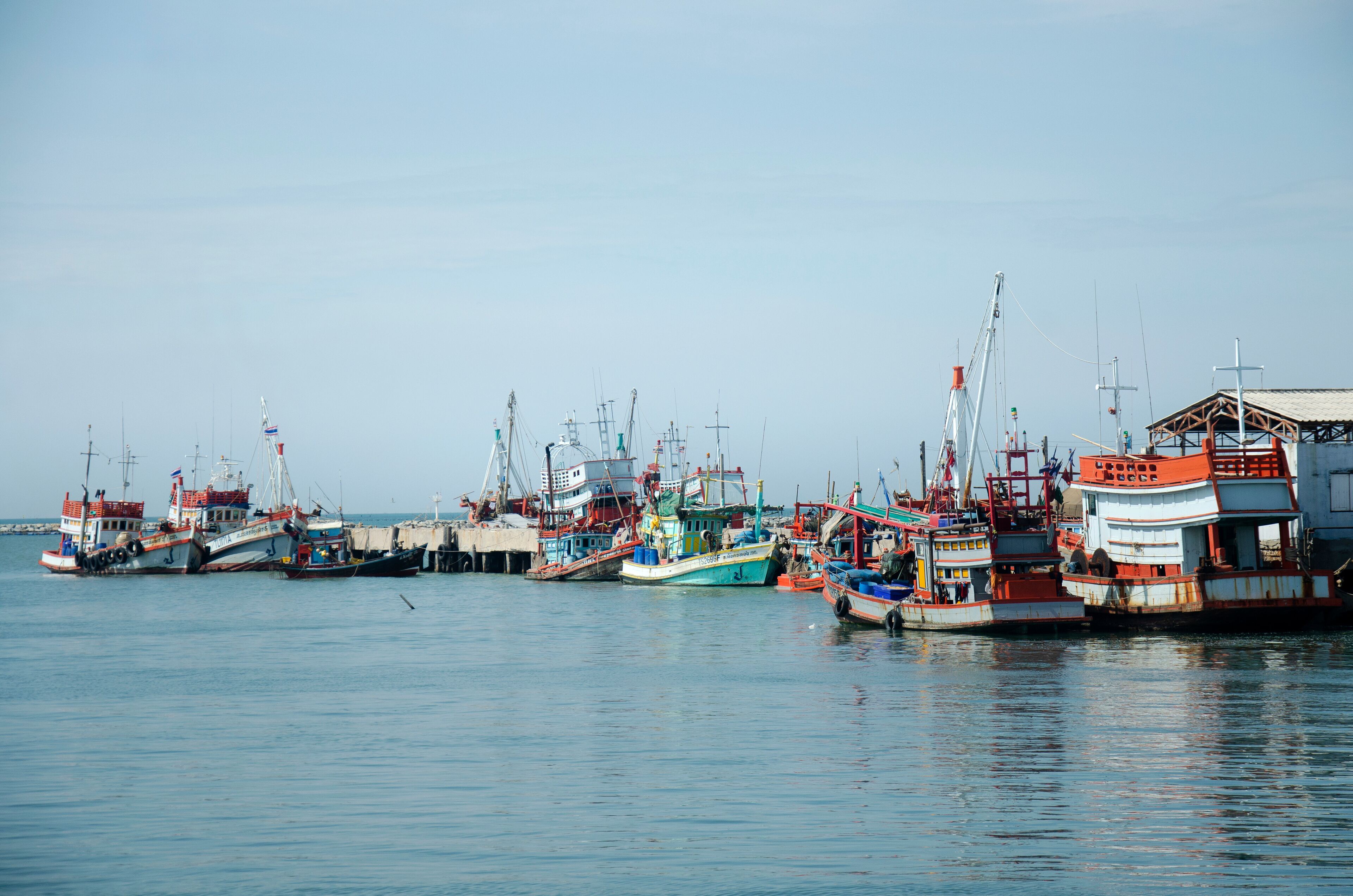 Fishing boat and ship floating in the sea for waiting fishing in night time at Ang Sila in Chonburi, Thailand