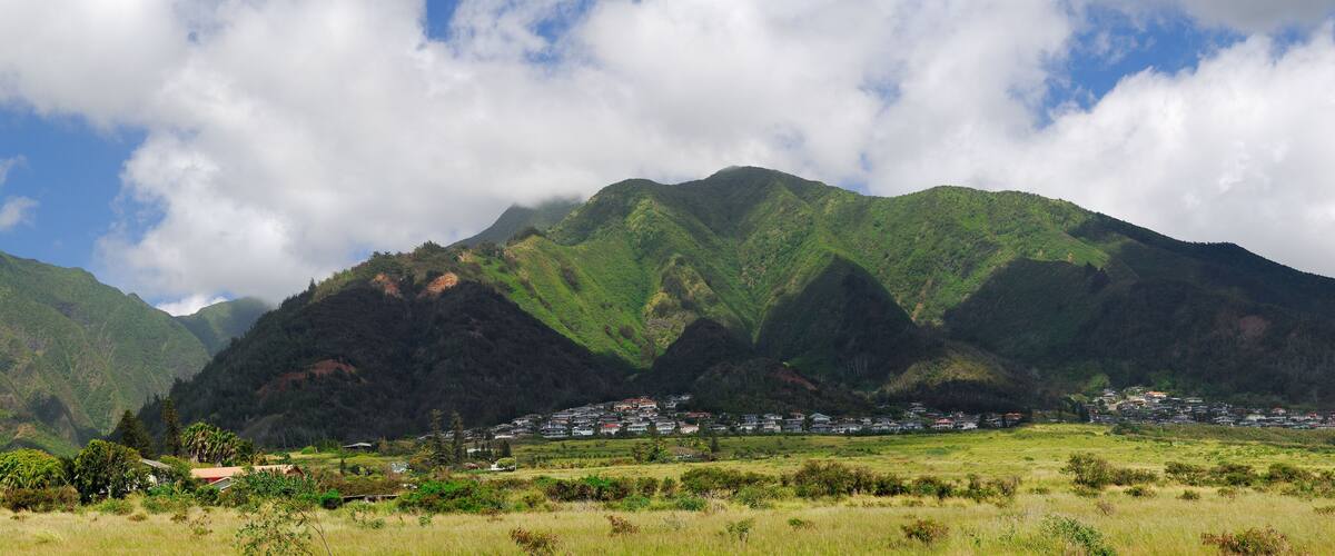A mountainous landscape with a village nestled in the valley.