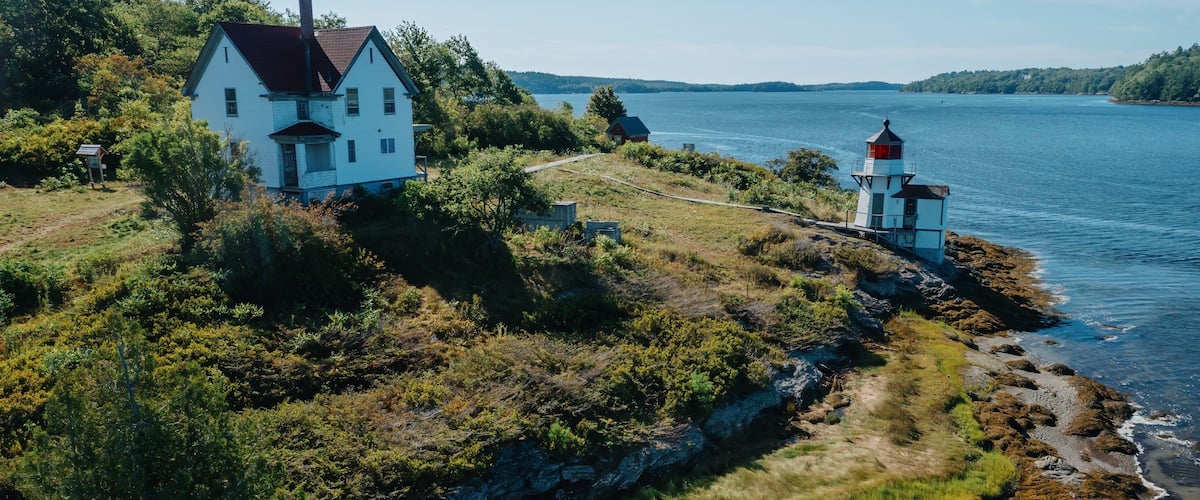 Historic Squirrel Point Light and cottage along the coastline, Phippsburg, Maine, United States.