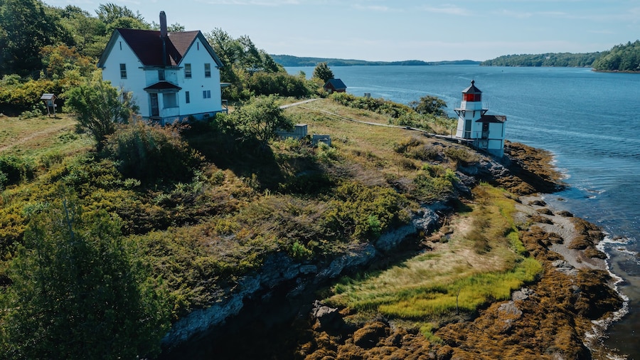 Historic Squirrel Point Light and cottage along the coastline, Phippsburg, Maine, United States.