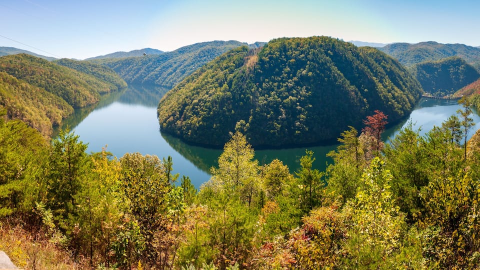 A lake surrounded by forested hills.