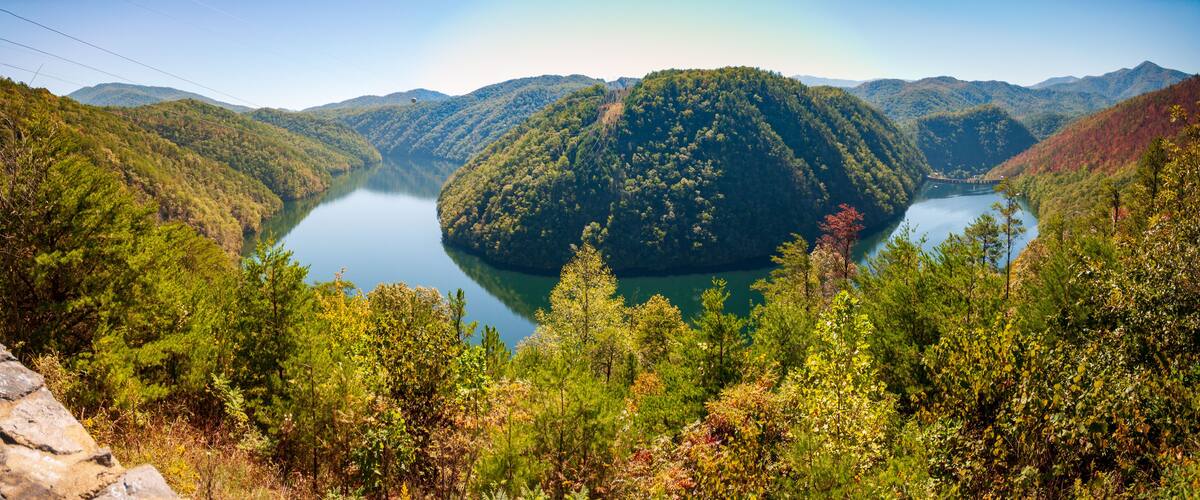 A lake surrounded by forested hills.